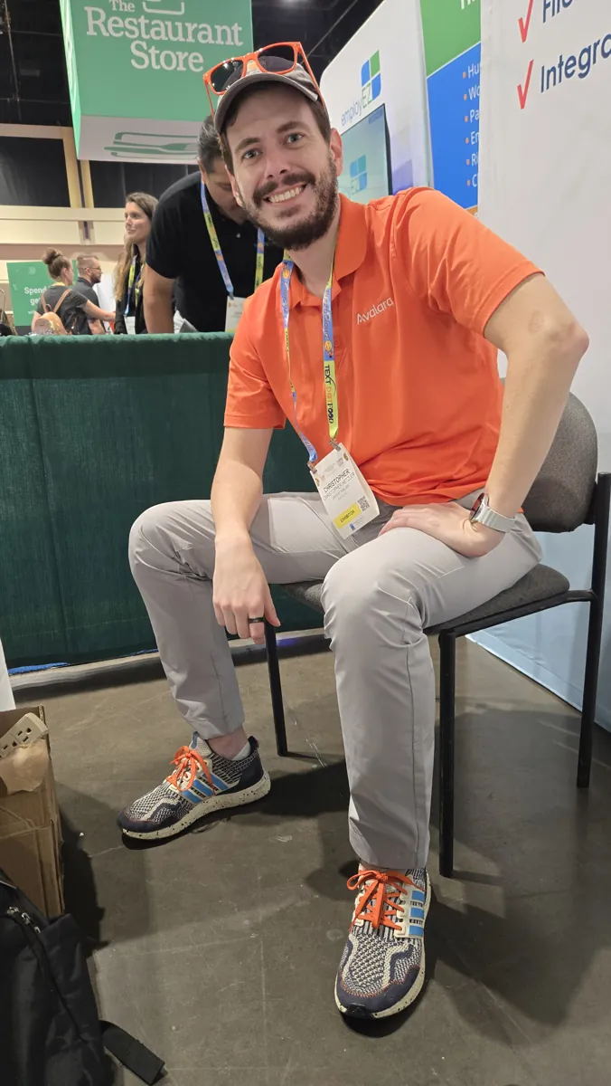 Chris Hetzler in an Avalara polo at the DAVO booth